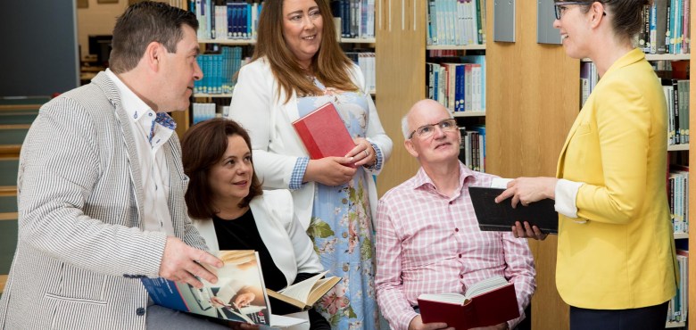 Group of adults reading in a library