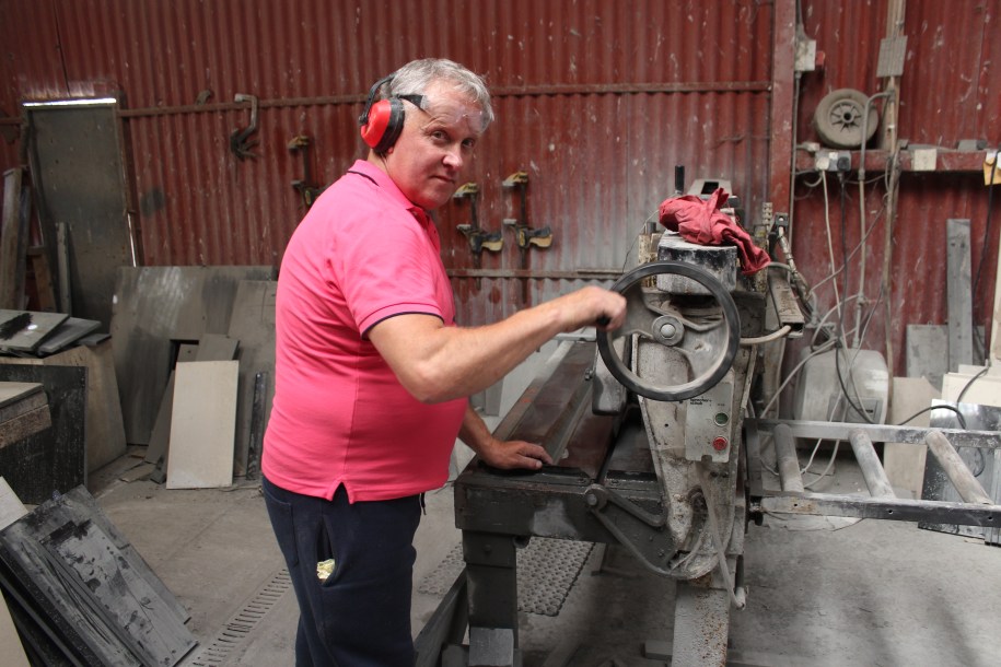 NALA Student ambassador Maurice shows how he works at a metal cutting tool