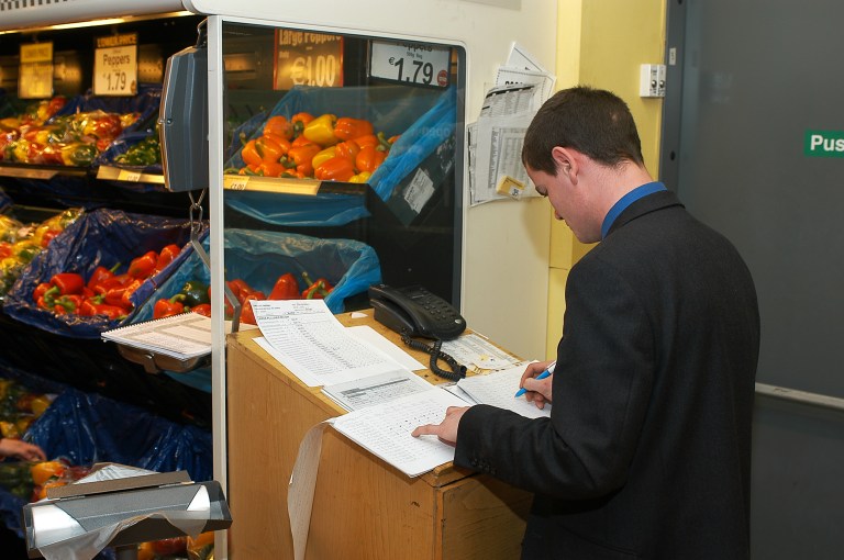 Staff at a supermarket checking products' stock level