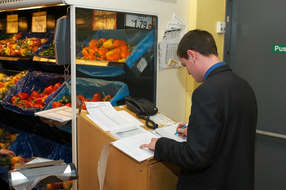 Staff at a supermarket checking products' stock level