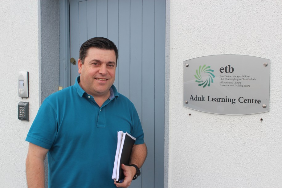 A NALA student in front of the door of the Kilkenny and Carlow ETB