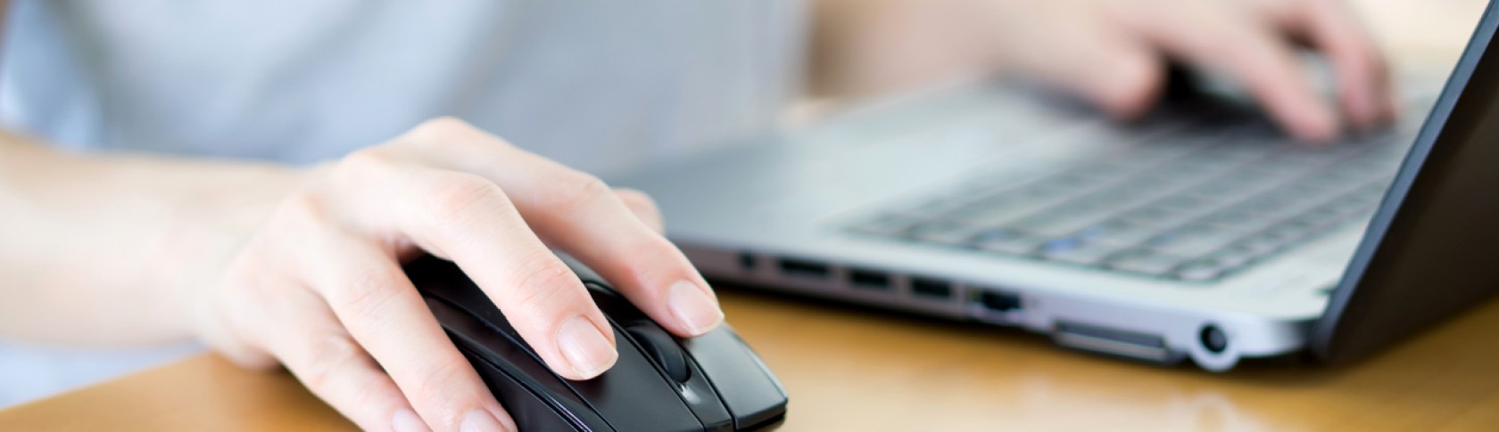 Closeup of woman hand clicking mouse outdoor