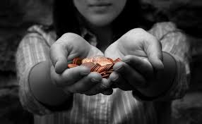 Stock image: a young woman in black and white colours holding coloured coins