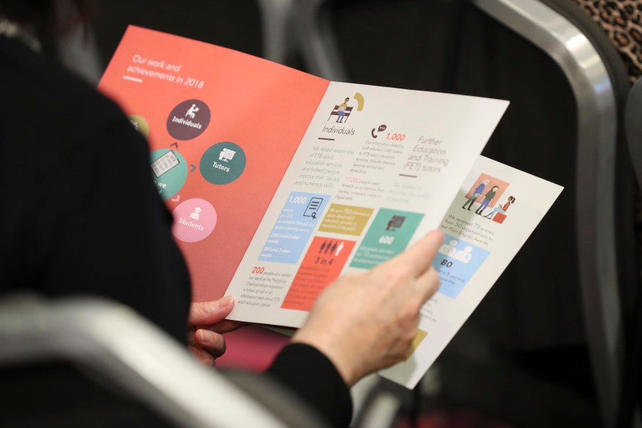 Zoom image of a woman reading NALA report 2018