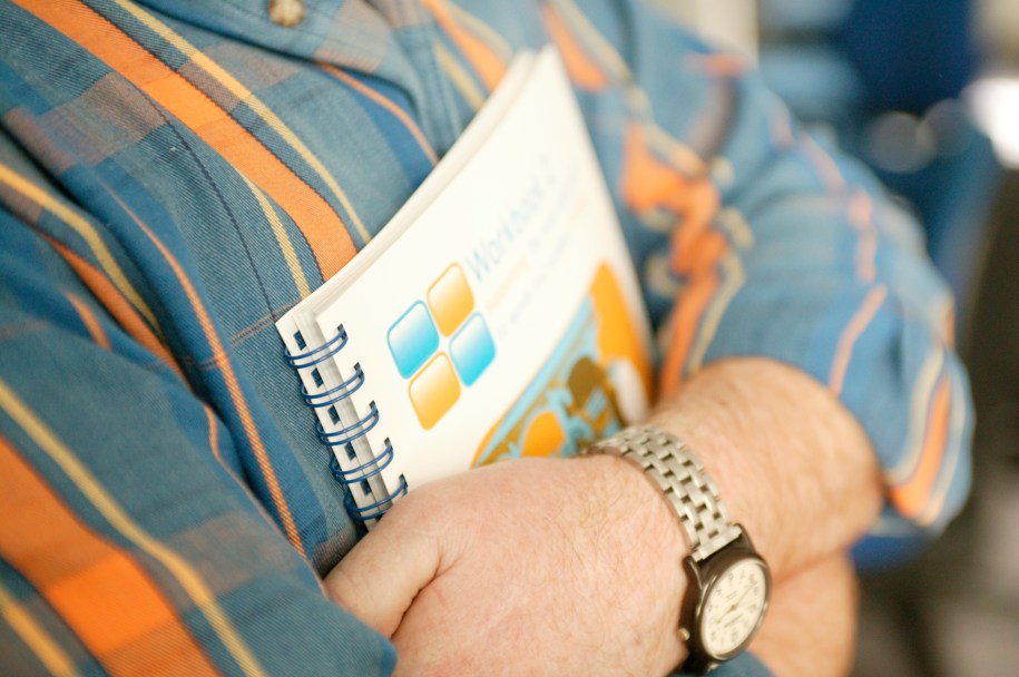 cropped image of arms holding a book