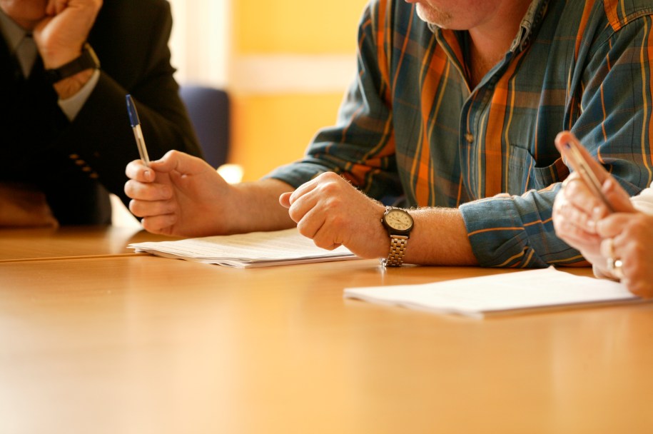 two people sitting at a desk table