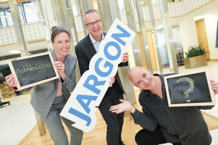 People holding a sign "Jargon" with former NALA CEO Bailey