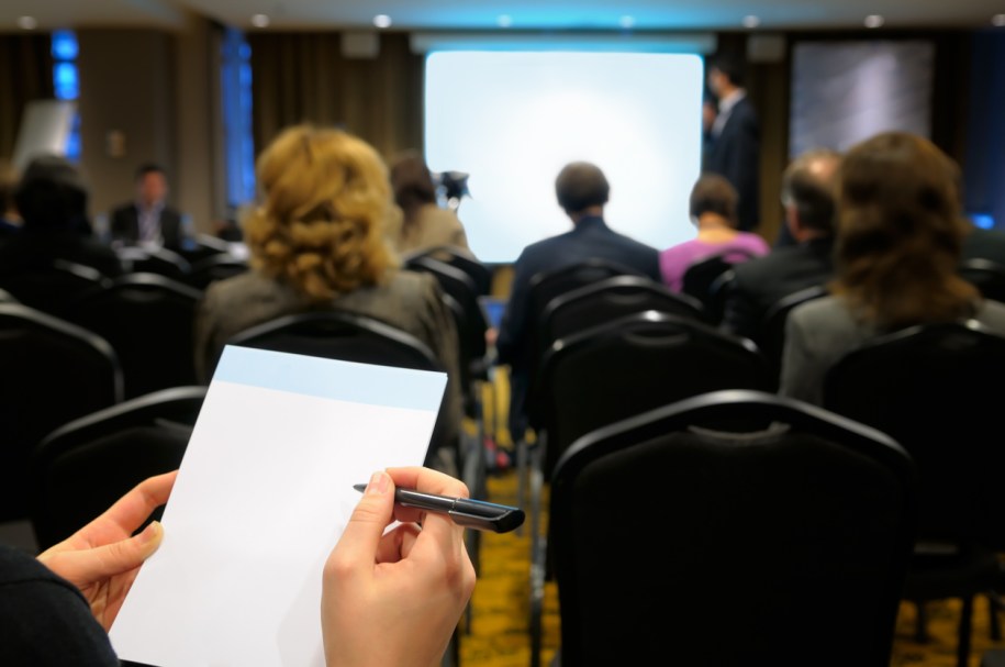 Notebook in women's hands against the background of the business room