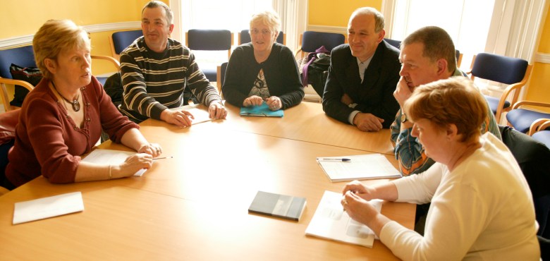 People sitting around a table. Stock image
