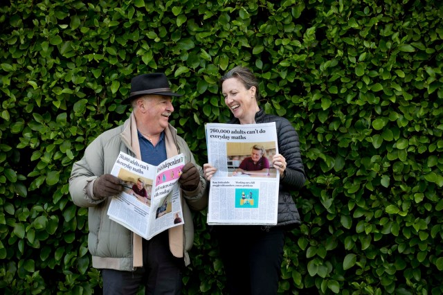 Two adults reading newspapers about adult literacy