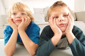 Stock image: 2 kids with hands on their face.