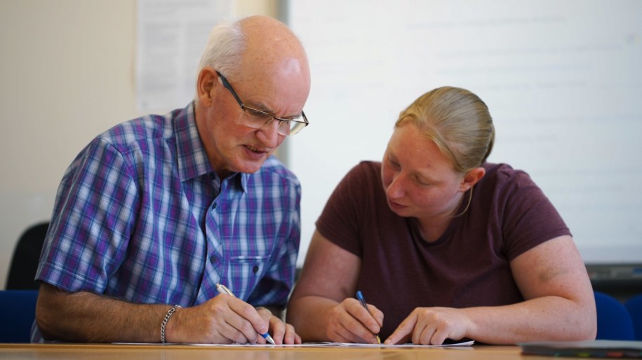 Tutor and adult student in class