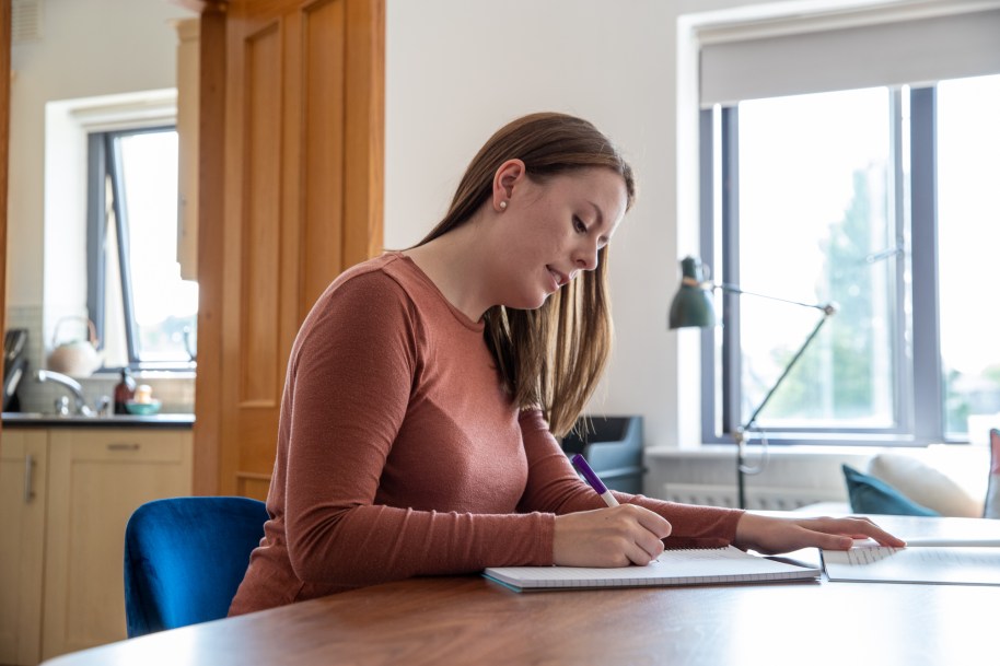 Woman writing at a table