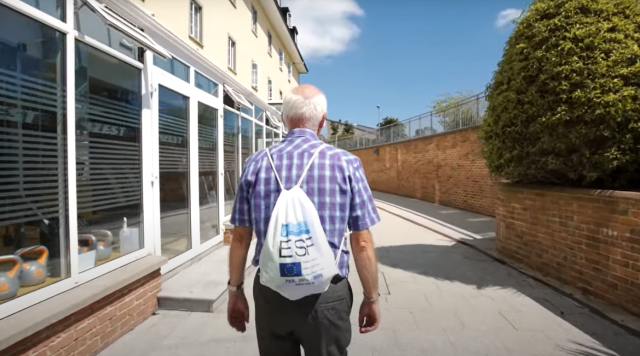 Image of a man walking to an education centre