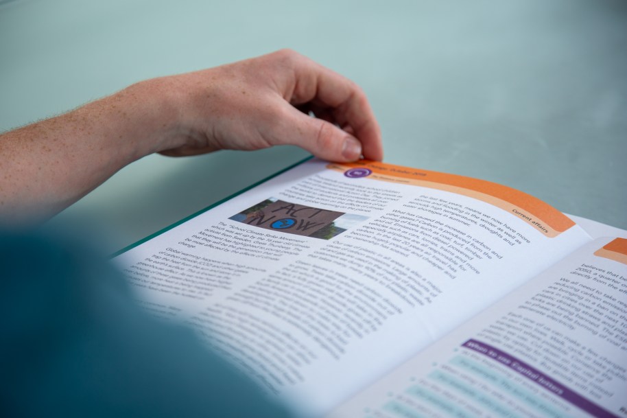 Person reading an education workbook