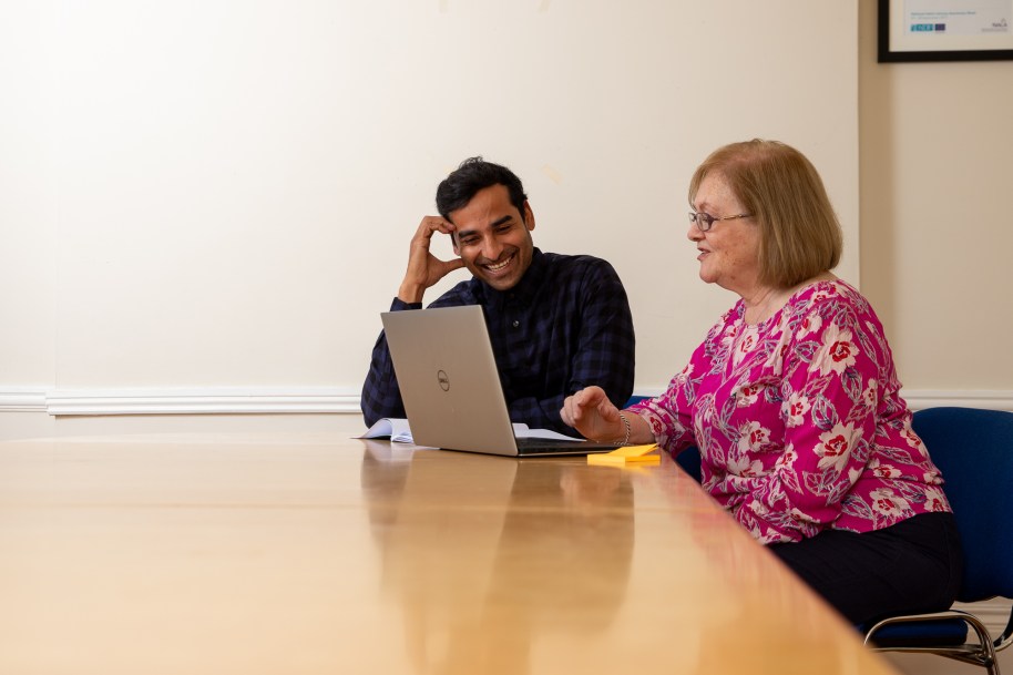 Two people looking at a laptop