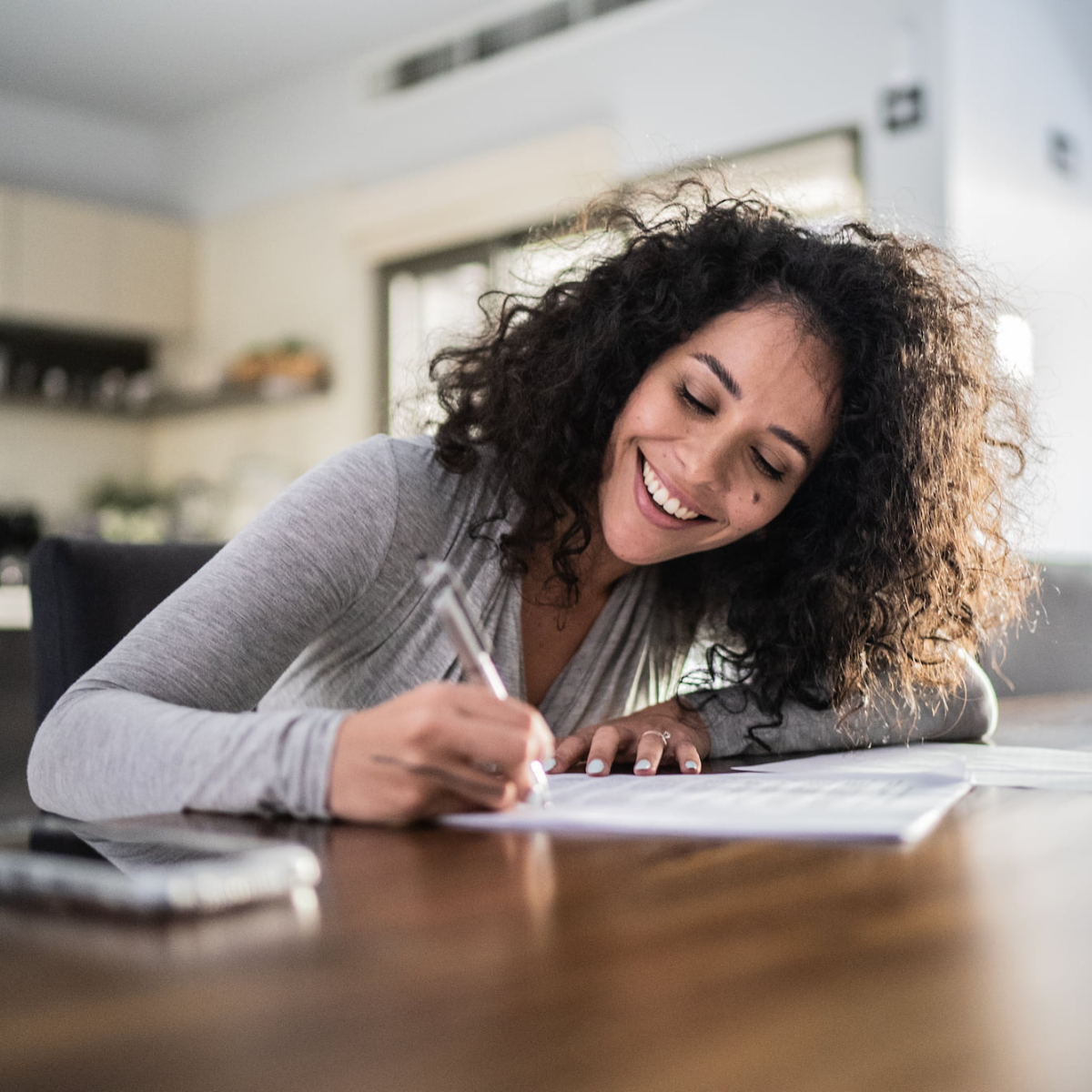 Woman writing on a workbook