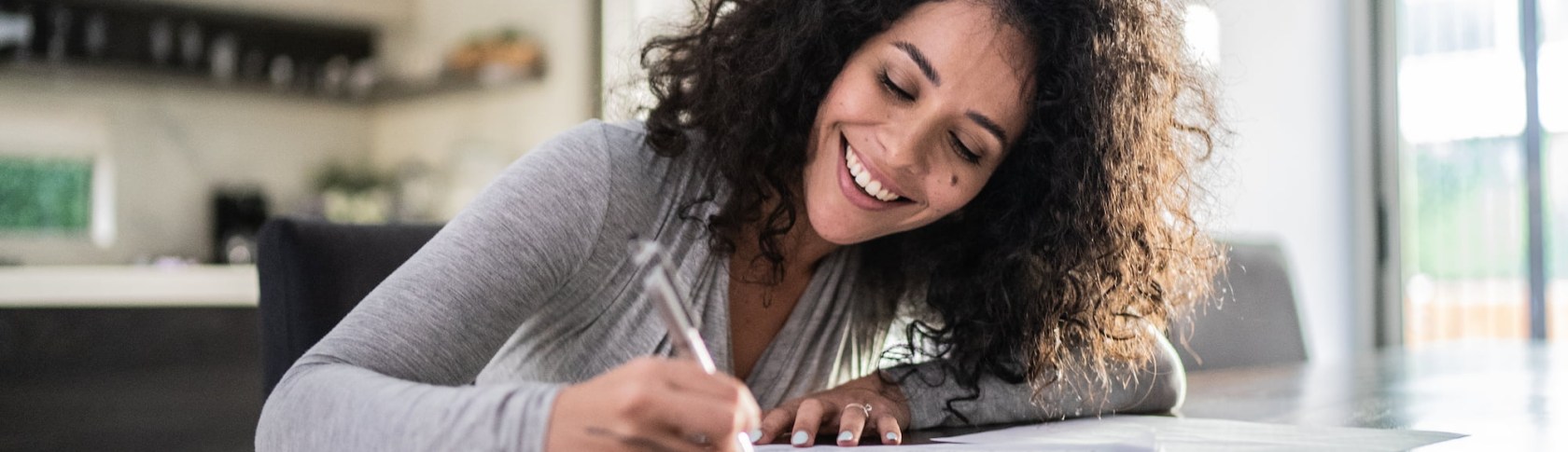 Person writing documents at home