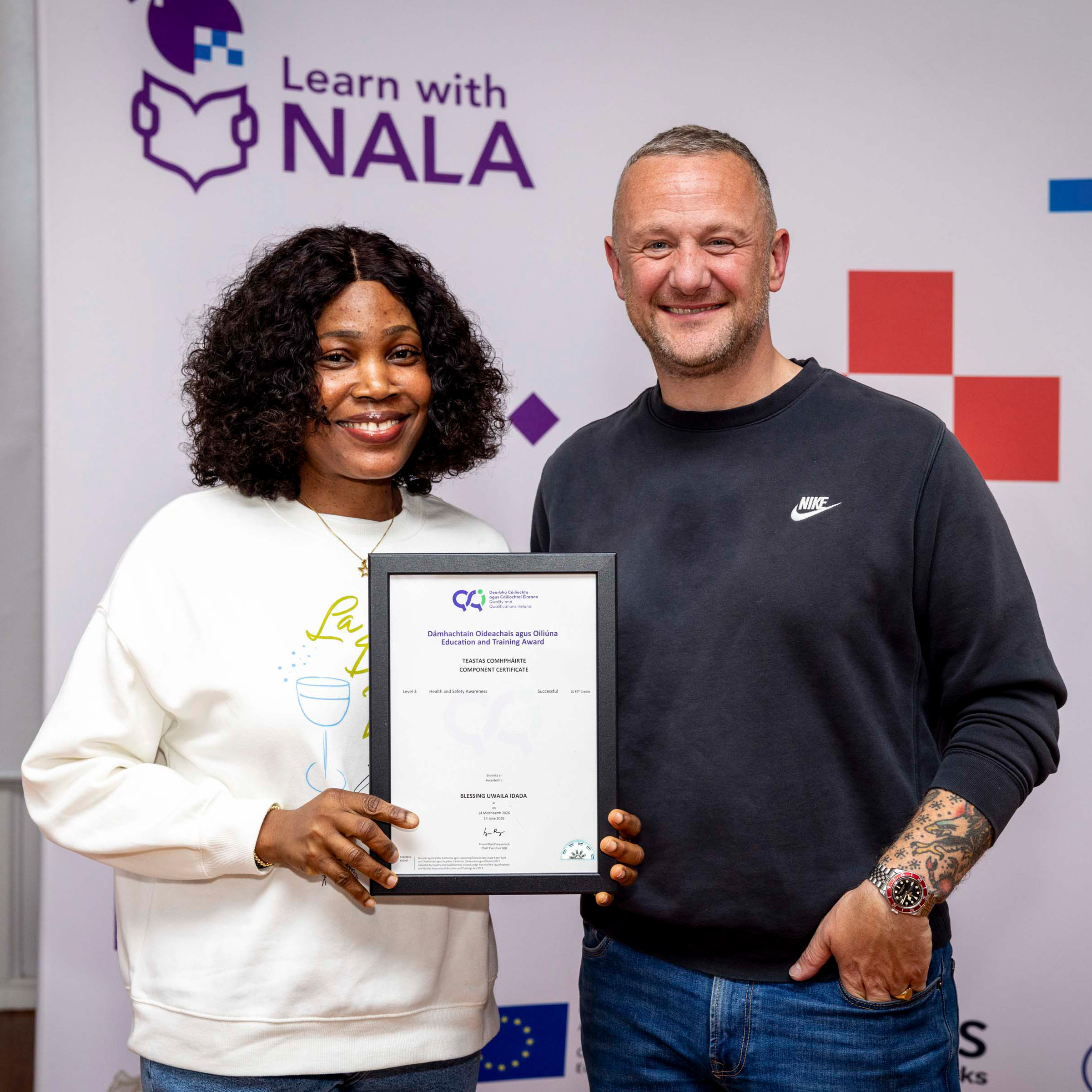 Learn with NALA learner Blessing receiving an award from PJ Gallagher