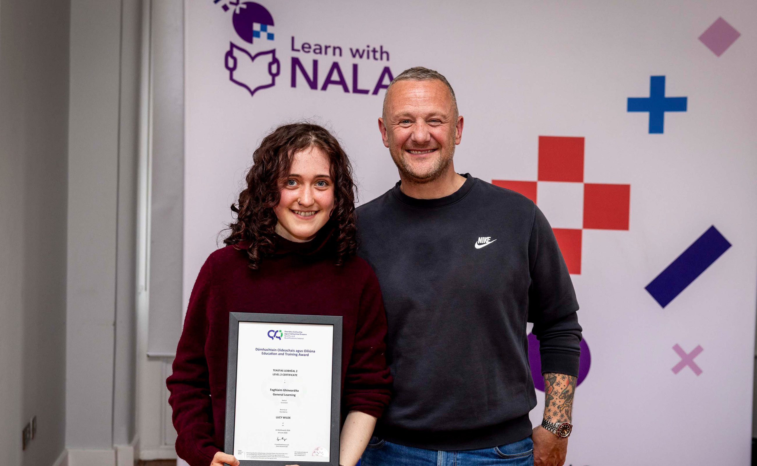 Learn with NALA learner Lucy receiving award from PJ Gallagher